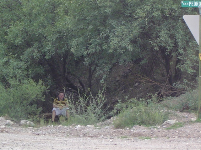 Drew hiding under a tree.