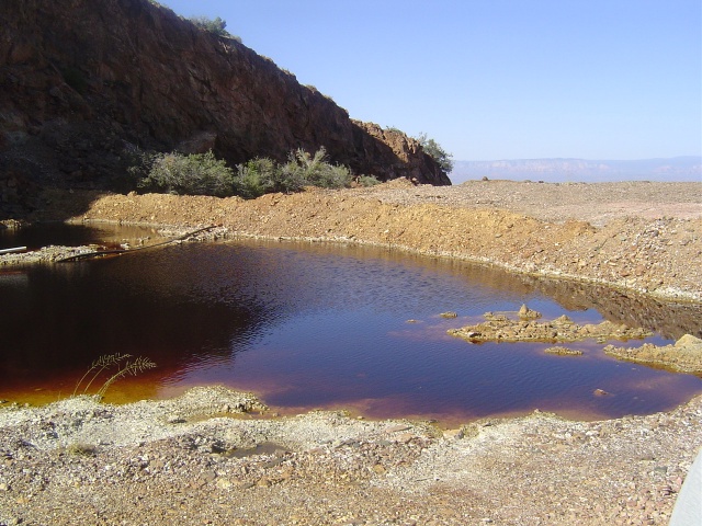 A cess pool filled with iron sludge. 