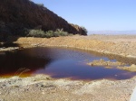 A cess pool filled with iron sludge. 