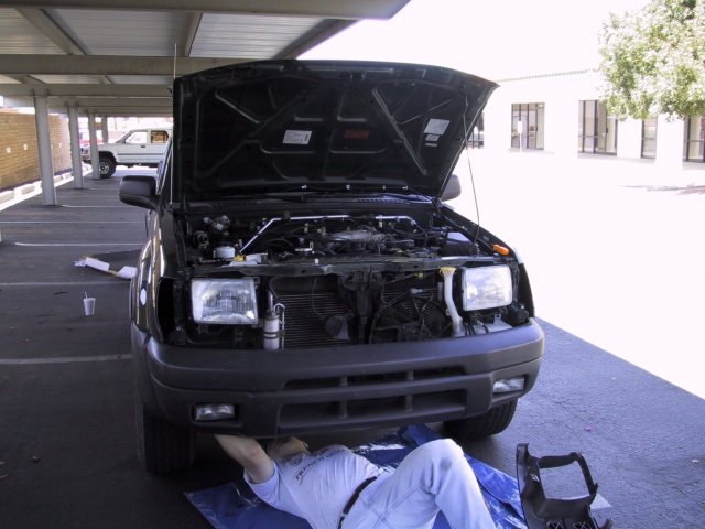 Matt unbolting the stock bumper.  Grill is already off.
We broke plastic tabs and had to buy new ones.  Gus got them for me.